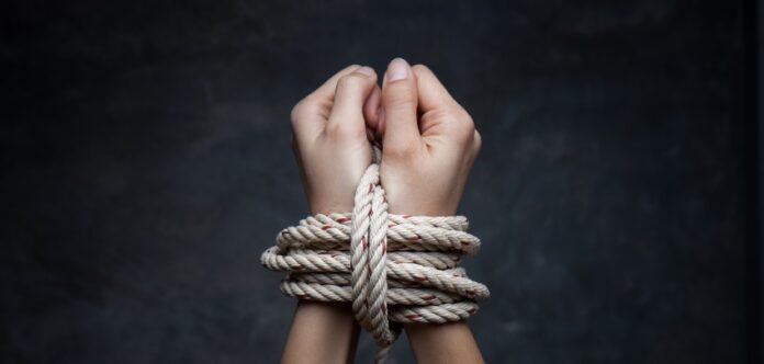 Hands of a missing kidnapped, abused, hostage, victim woman tied